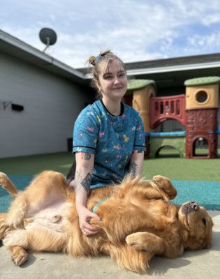 a woman sitting on a dog