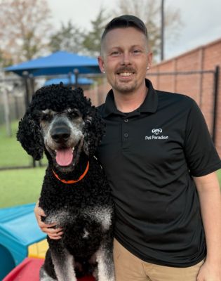 a man holding a dog