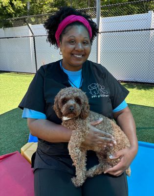 a woman holding a dog