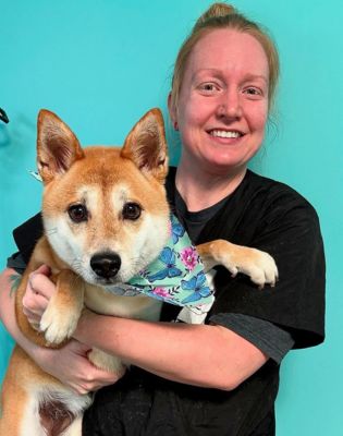 a woman holding a dog